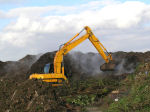 Jcb working with green waste windrows at composting site